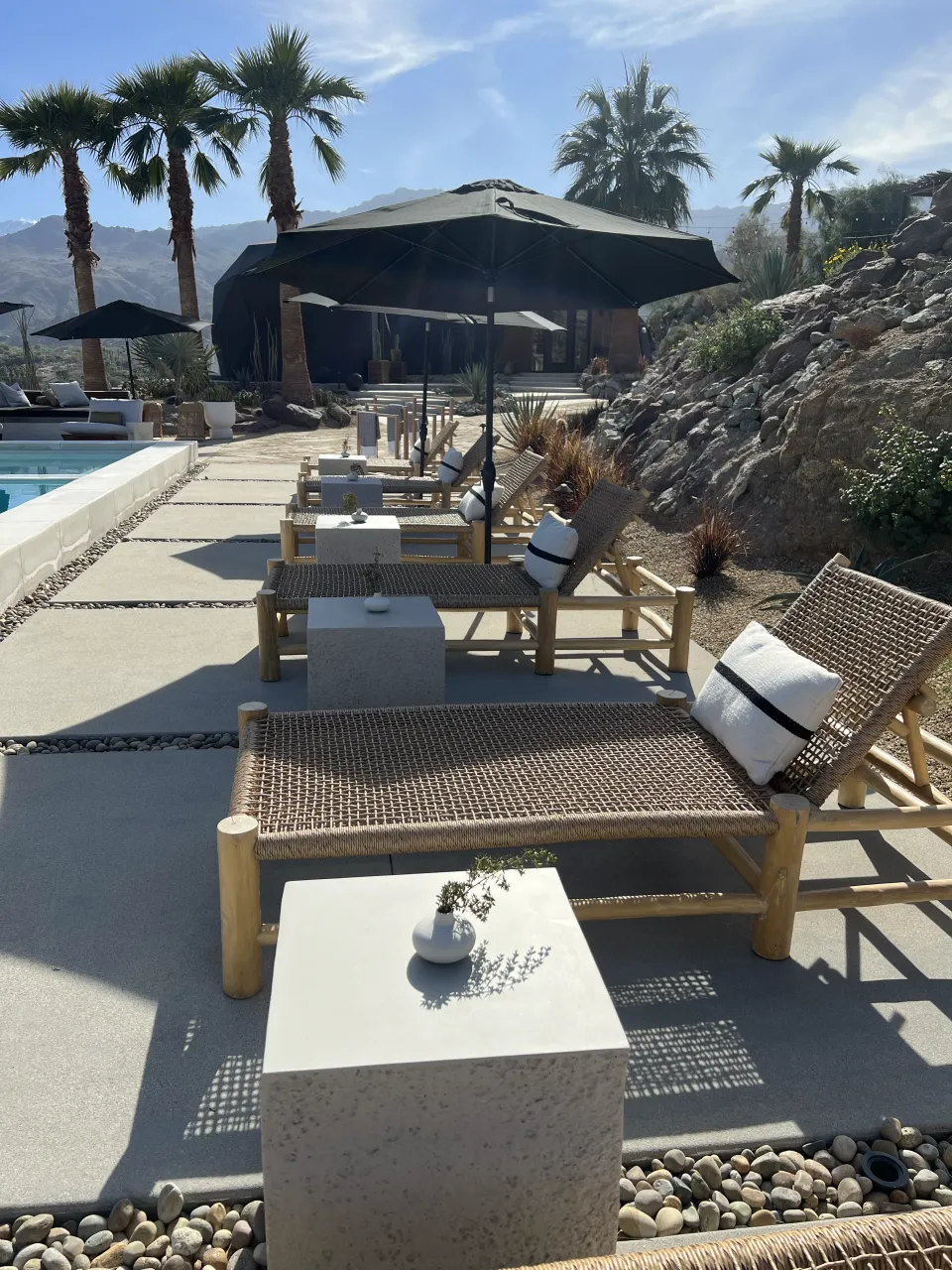 Reupholstered outdoor patio furniture with cushions and umbrellas by Lesley's Upholstery